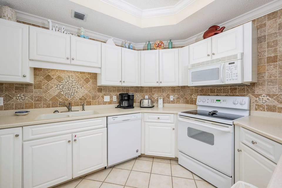Craft delightful meals in this cheerful kitchen with a coffee maker with Keurig and traditional style brews