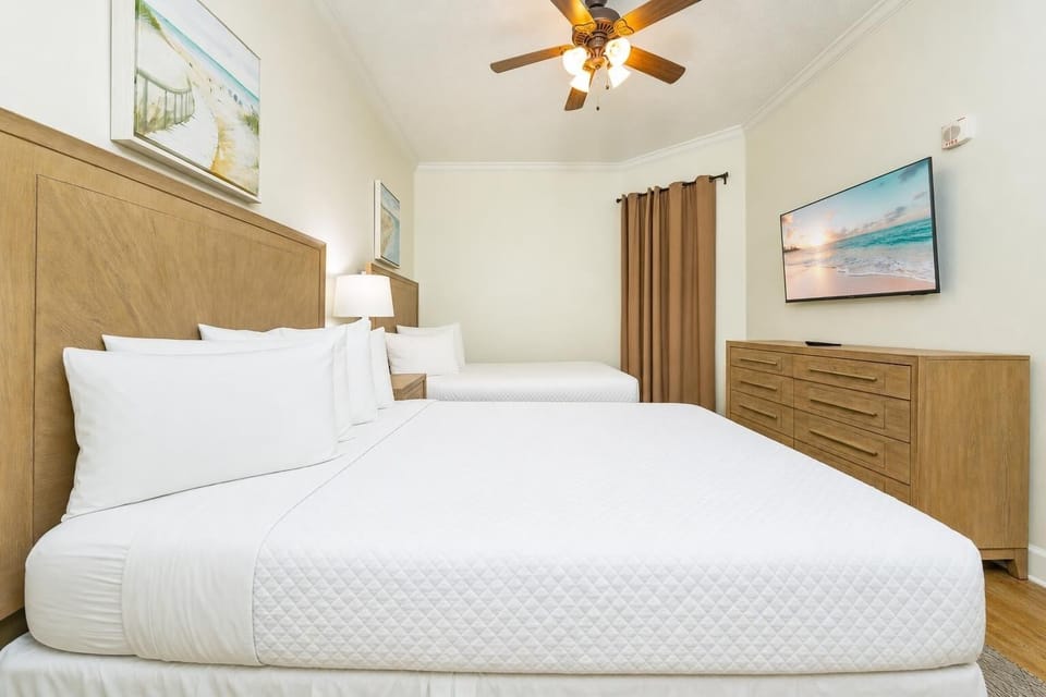 Two queen guest suite invites you to stretch out and unwind while watching your favorite shows on TV