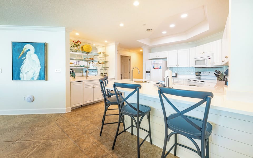 Gather around the breakfast bar in the bright kitchen while sharing stories and planning your next beach day