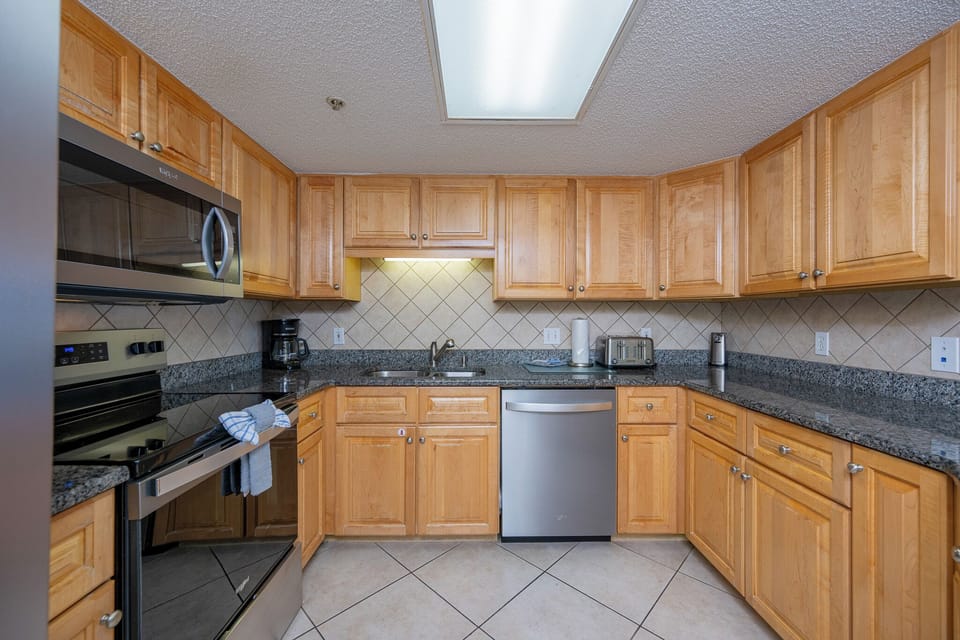 Smooth granite counters surround you as you prepare meals in the cozy kitchen with stainless appliances