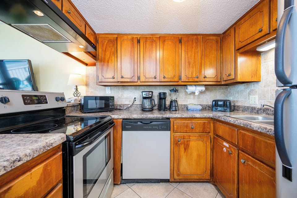 Craft your favorite meals in this inviting kitchen, surrounded by warm wood tones and stainless appliances