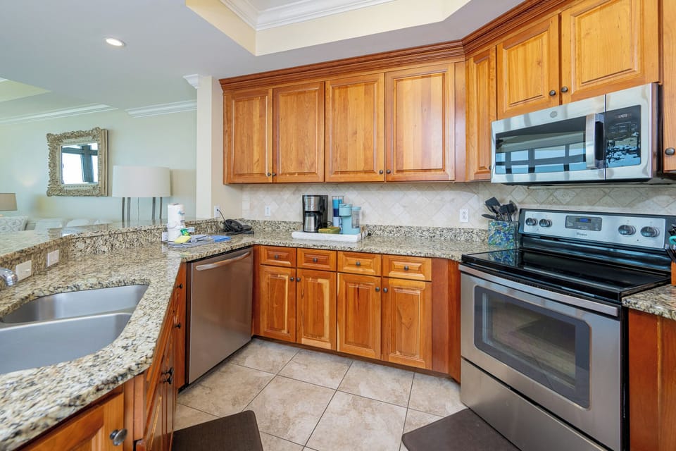 Experience the joy of preparing meals in this inviting kitchen, where modern amenities enhance your stay