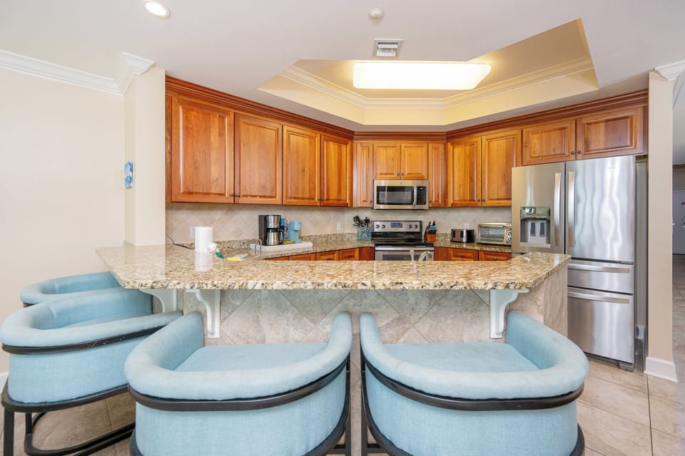 Gather your family at the cozy kitchen bar, enjoying casual chats and delicious snacks in your beach retreat