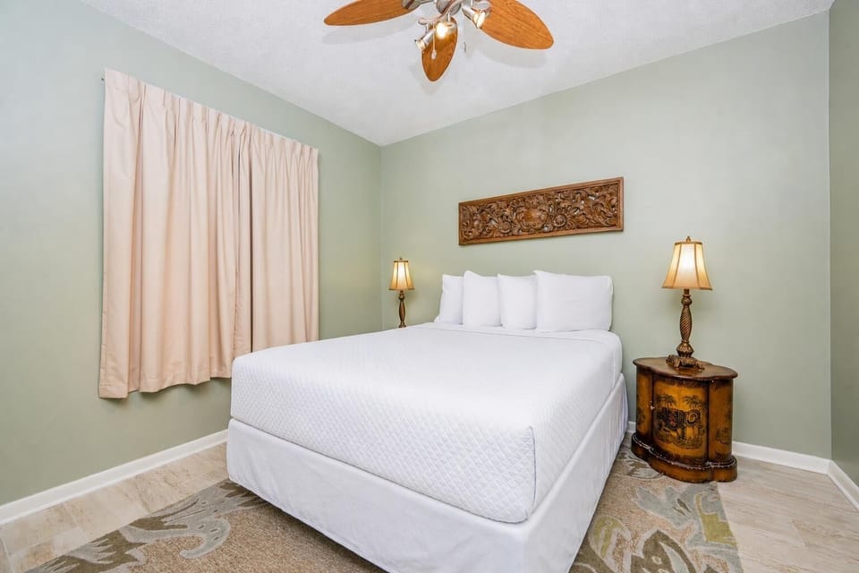 Rest comfortably in this inviting guest room featuring a queen bed, decorative accents, and soft lighting for a restful stay