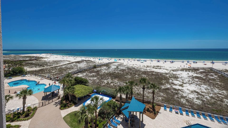 Take in the beautiful view of the beach and inviting pools from this spacious outdoor area, perfect for relaxation