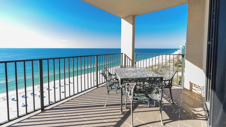 Relax at the outdoor dining table while enjoying sweeping views of the water and coastline from the top floor