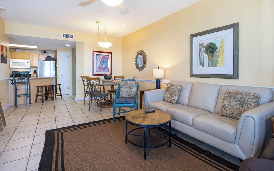 Relax in the inviting living area, featuring a comfortable sofa and a round dining table for shared meals and conversation