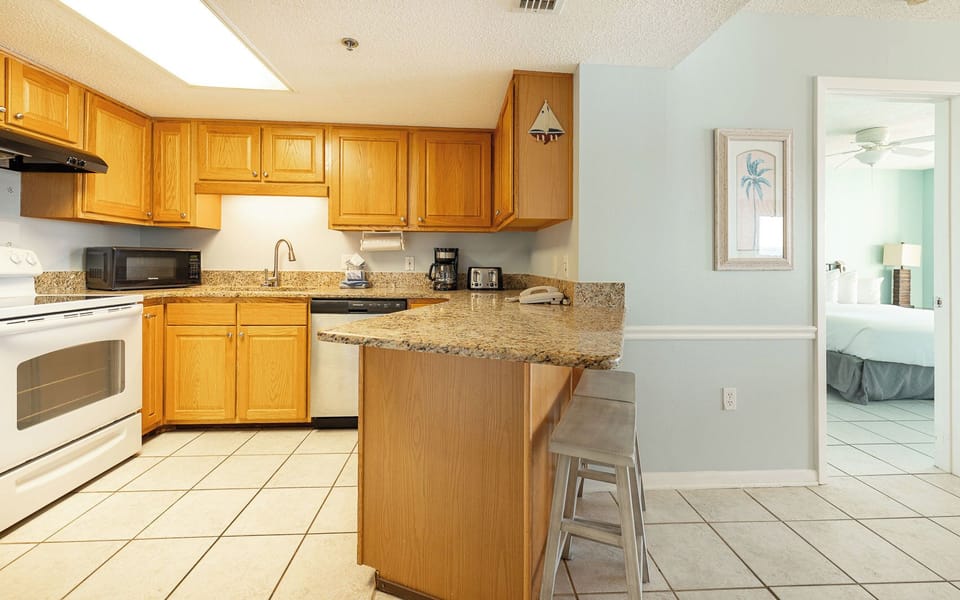 Your family gathers at the breakfast bar sharing morning laughter as the kitchen hums with fresh coffee scents