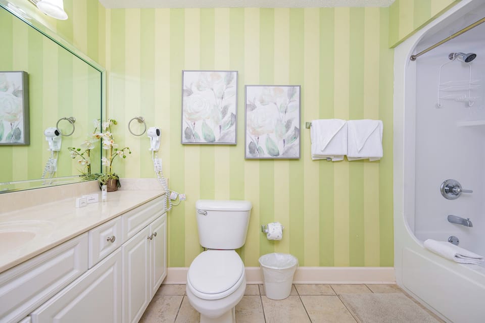 Refresh your spirit in this guest bath, where serene decor invites you to unwind after beach adventures