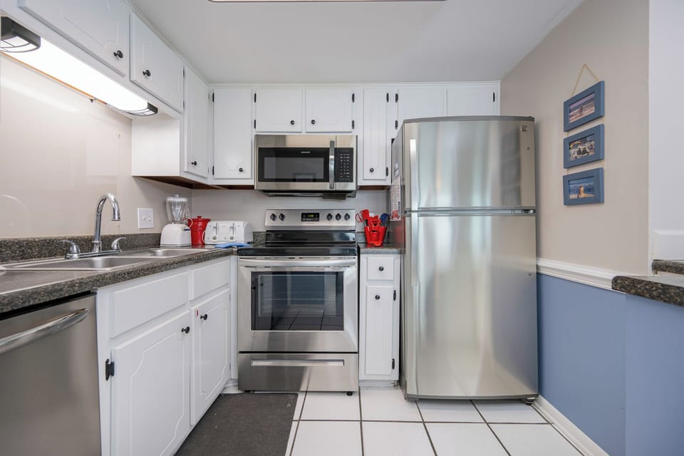 Enjoy making meals together in this inviting kitchen space, complete with stainless appliances and cozy decor