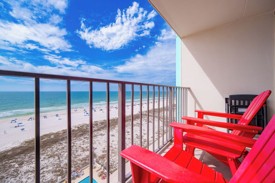 Relax in vibrant chairs on your balcony while soaking in breathtaking coastal views and the soothing surf sounds