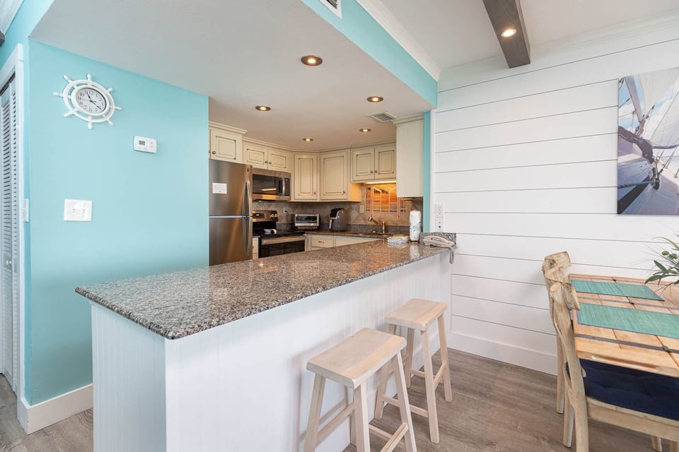This kitchen features granite countertops, stainless appliances, and a cozy dining area, perfect for family meals
