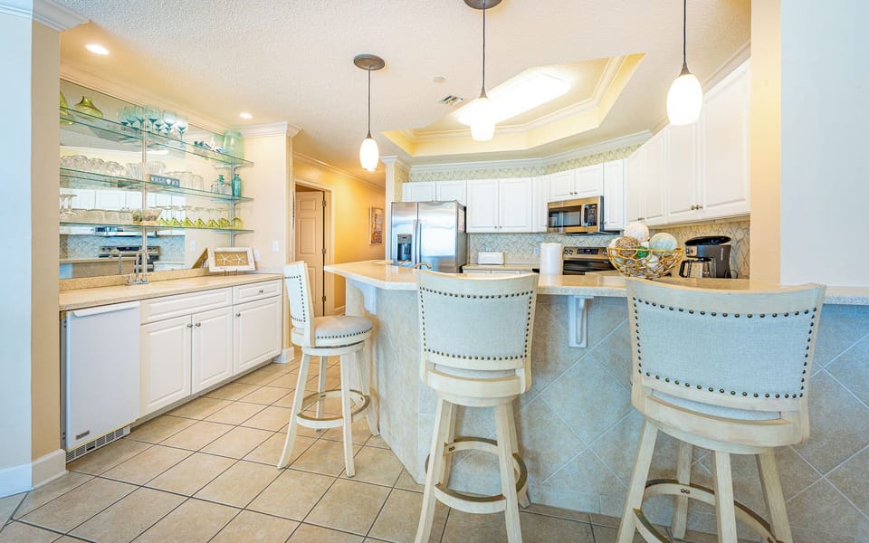 A bright kitchen with breakfast bar seating where you can chat while preparing fresh meals together