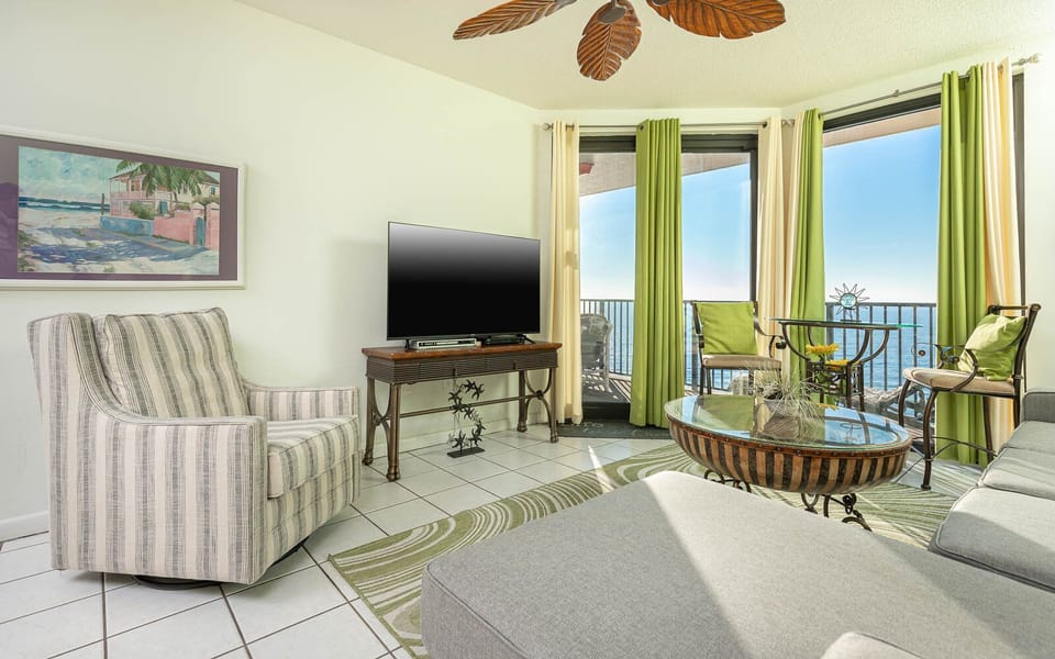 Relax in the inviting living area with a cozy couch, stylish decor, and views from the balcony seating