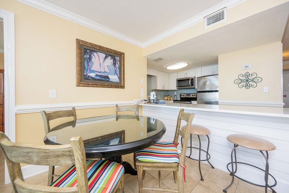 Savor meals and laughter around your round dining table, where coastal charm enhances family moments