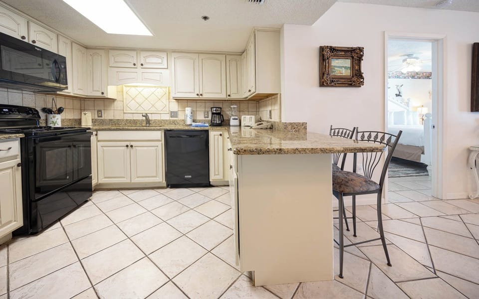 Prepare meals in the spacious kitchen featuring granite countertops and a convenient breakfast bar