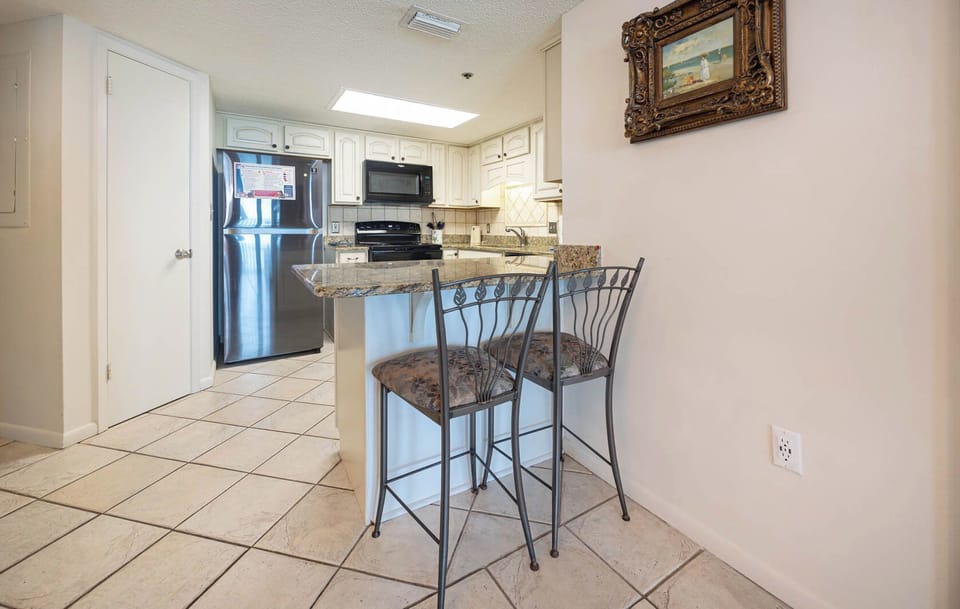 Gather around the stylish bar stools at the kitchen island, perfect for casual meals and conversation