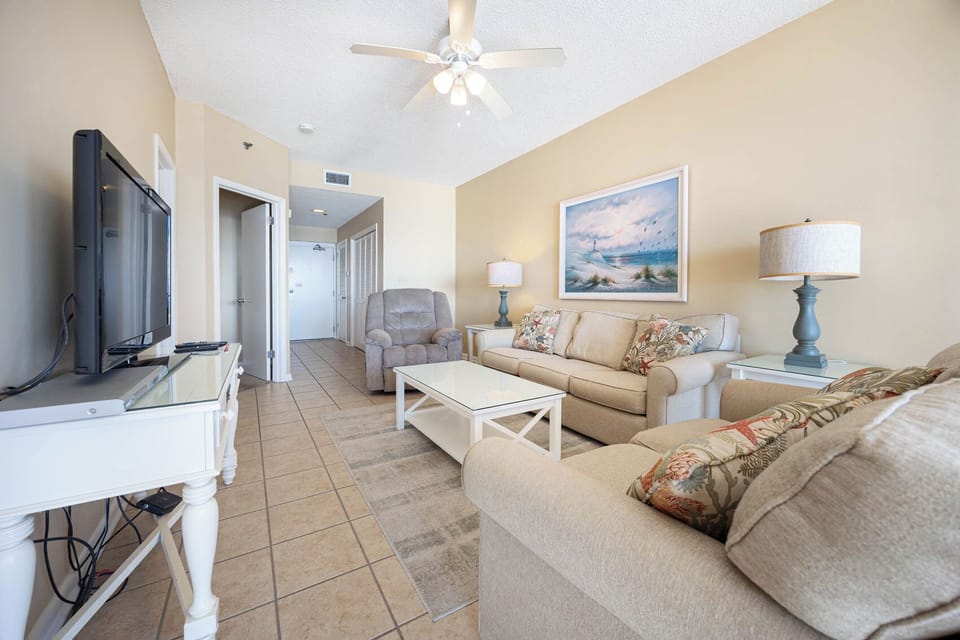 Unwind in the inviting living area, featuring a sofa with queen sleeper and coastal decor