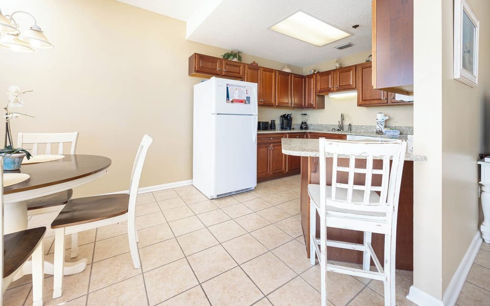 Enjoy meals with a beach view from this inviting kitchen with warm wood accents