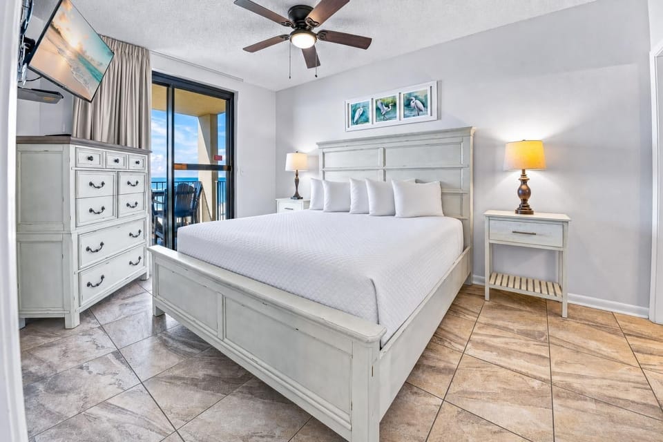King bed in the master suite invites restful nights with soft lamps glowing and a gentle coast breeze nearby
