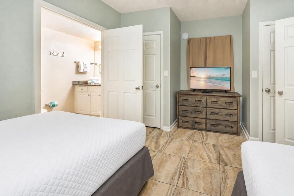Guest suite invites restful evenings with queen beds and a TV for cozy entertainment after your day outdoors