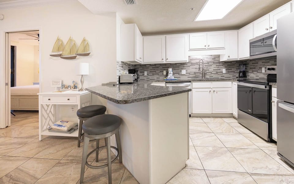Prepare meals at the stylish kitchen with sleek appliances and a cozy seating area, perfect for casual dining