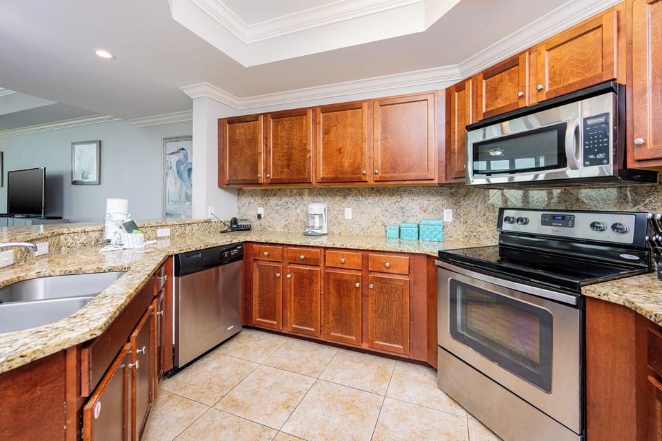 This modern kitchen features stainless appliances, granite countertops, and a breakfast bar for family meals and entertaining