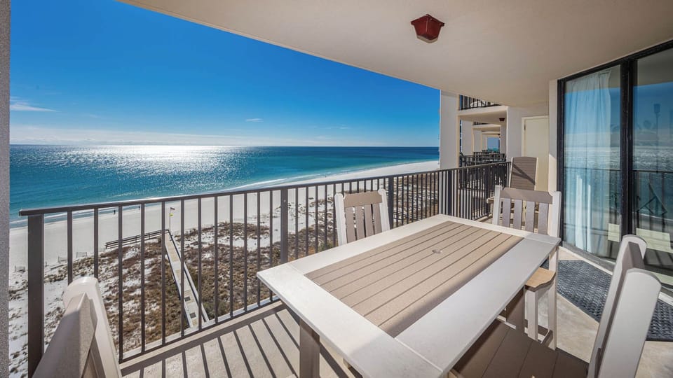 Enjoy meals or drinks at the outdoor table while taking in the beautiful water view from your balcony