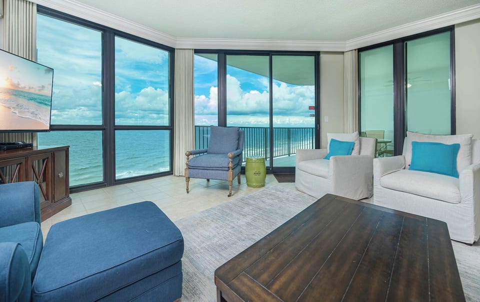 Relax in the comfortable living room featuring a sofa with queen sleeper while enjoying expansive beach views