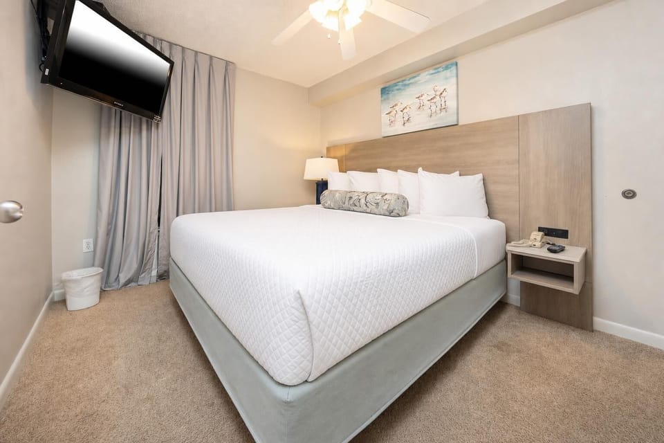 Unwind in this serene bedroom featuring a king bed, soft linens, and a cozy atmosphere for restful nights