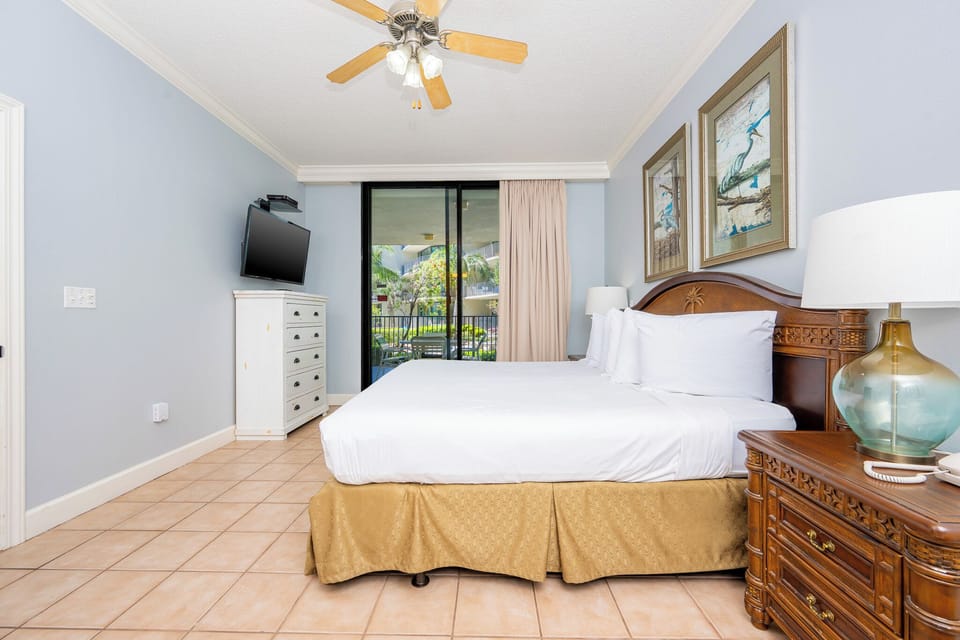 Retreat to the king master suite with cozy bedding and drift off to coastal sights and sounds of the bay