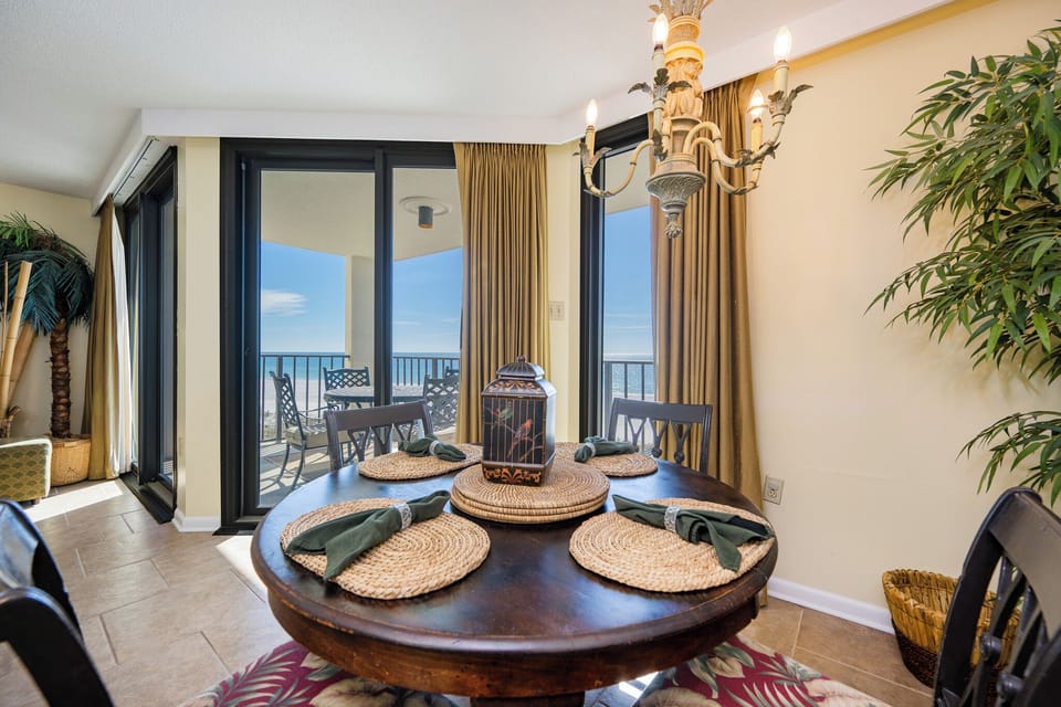 Sunlight fills the dining room where your family gathers around the round wooden table overlooking the shore