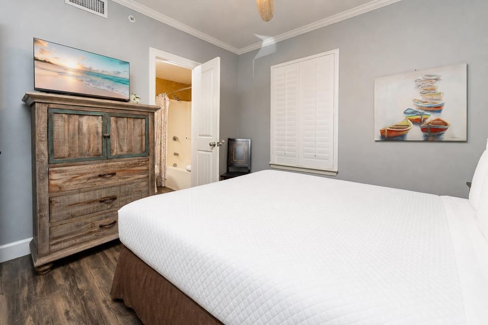 Soft sounds from the guest bath create a calm retreat as you unwind in this cozy guest suite with a queen bed