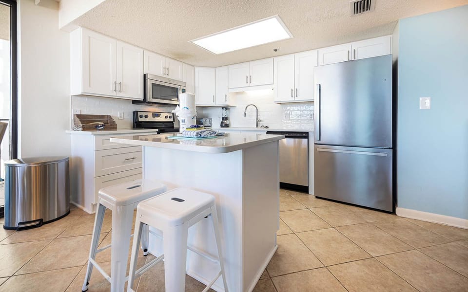 Prepare meals around the island while enjoying the sleek design and convenient layout of this inviting kitchen space