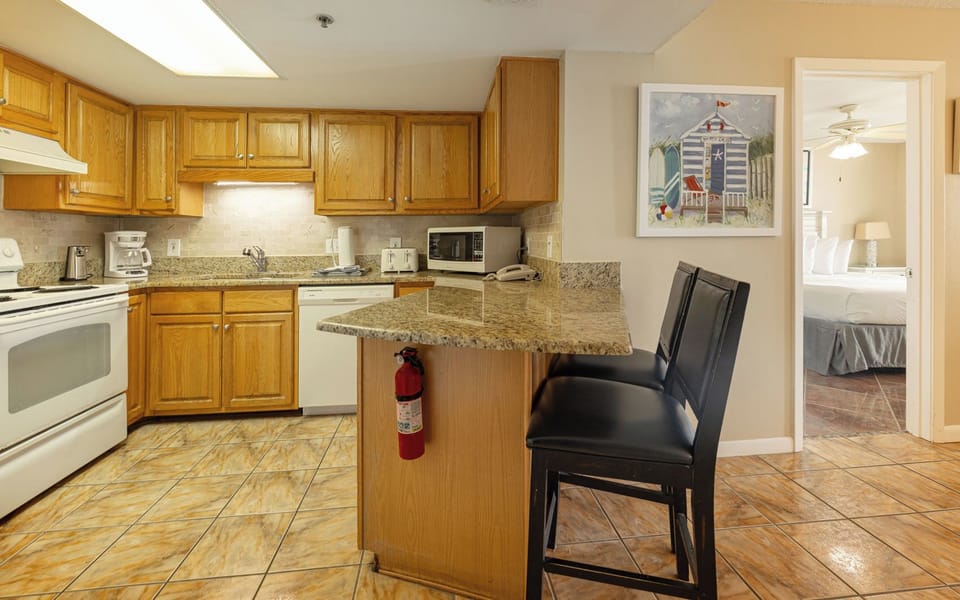 Soft tiles cool your feet as you sip morning coffee at the breakfast bar in the cozy kitchen nook