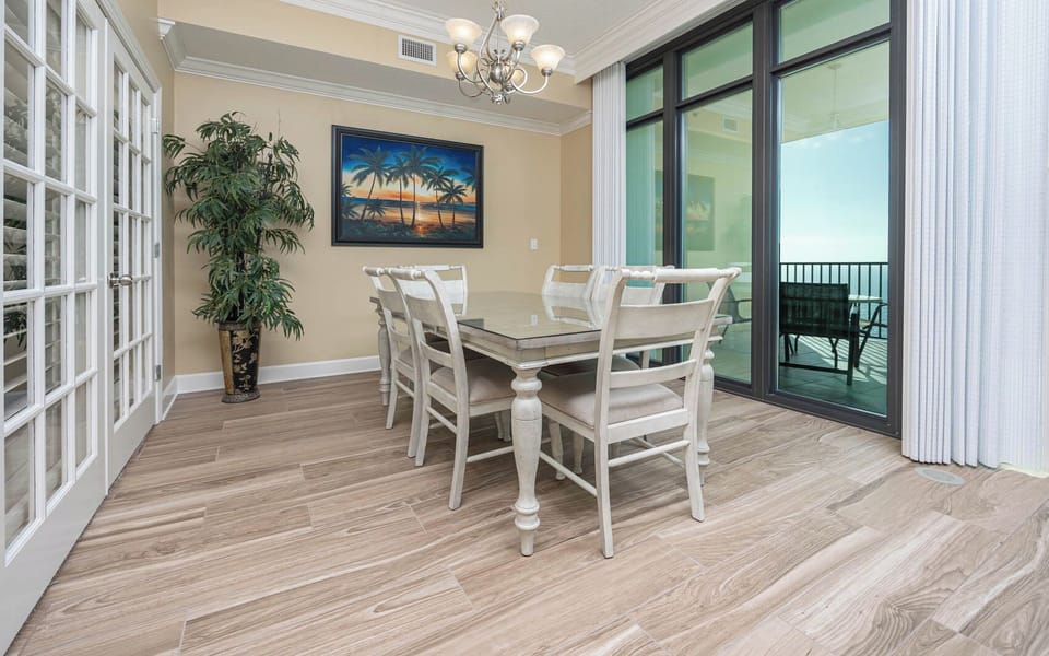 Gather around the elegant dining table, enjoying vibrant coastal views and creating lasting family memories