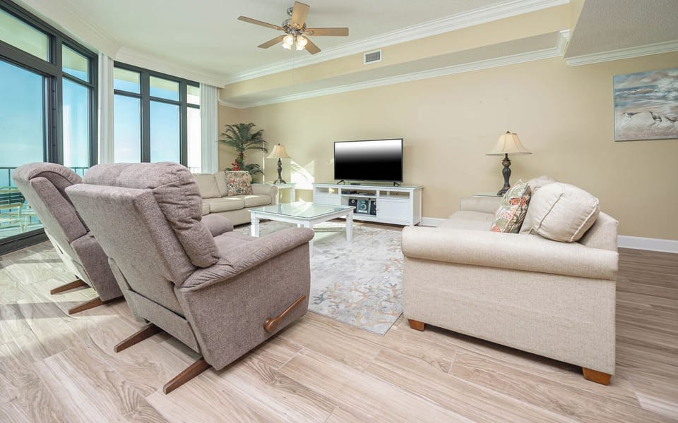Relax on the cozy sofa with a queen sleeper in this inviting family room with breathtaking beachfront views