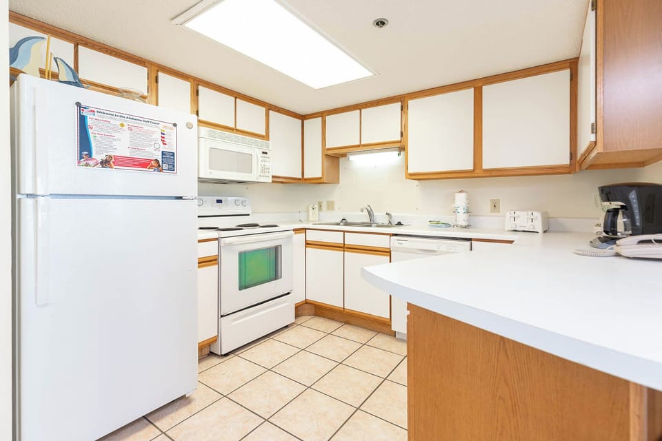Prepare meals in the kitchen featuring ample counter space, white appliances, and a welcoming vibe