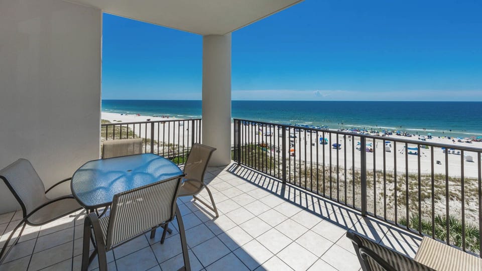 Enjoy stunning views from the balcony, featuring a glass-top table and chairs, perfect for relaxing in the sun