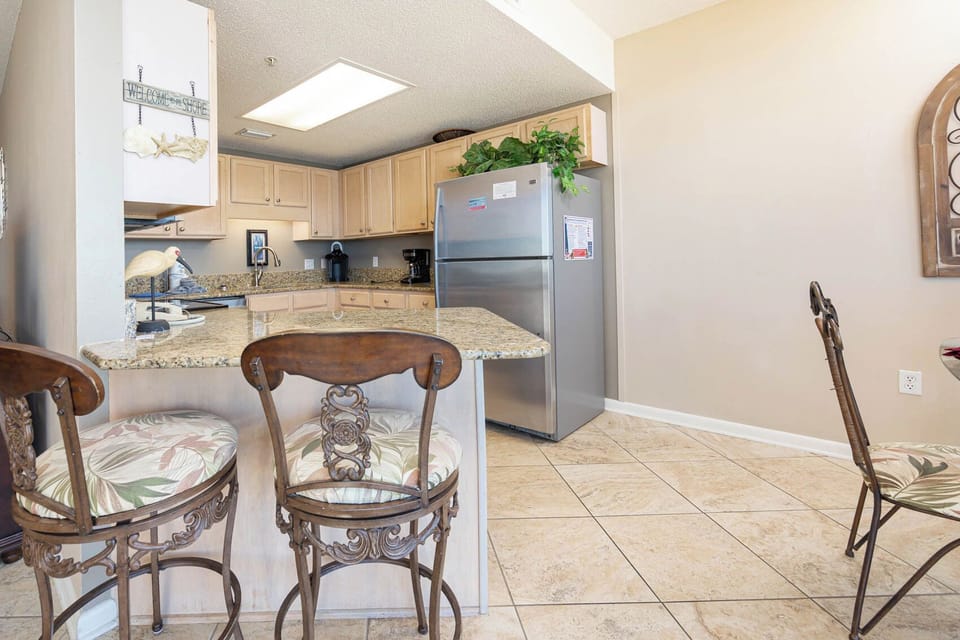 Gather around the stylish bar seating for casual meals while enjoying the inviting kitchen atmosphere
