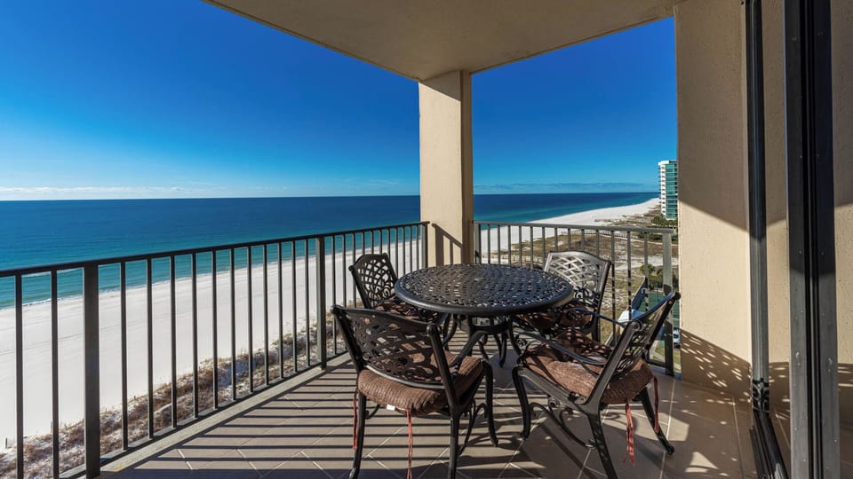 Enjoy meals or drinks at the round table on the balcony while taking in the expansive beach views