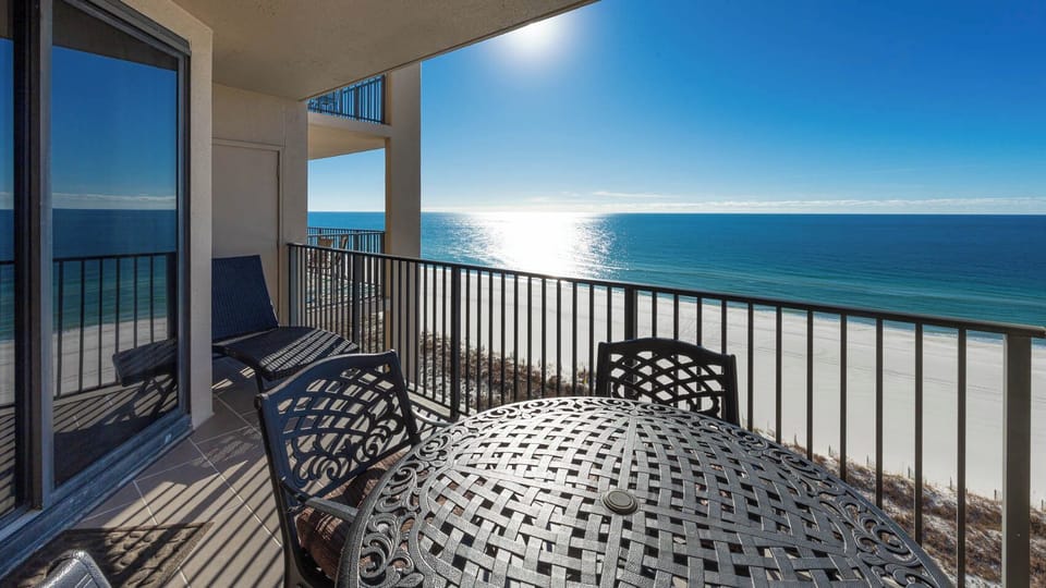 Savor meals at the round table while enjoying the serene beach views and gentle breeze from the balcony