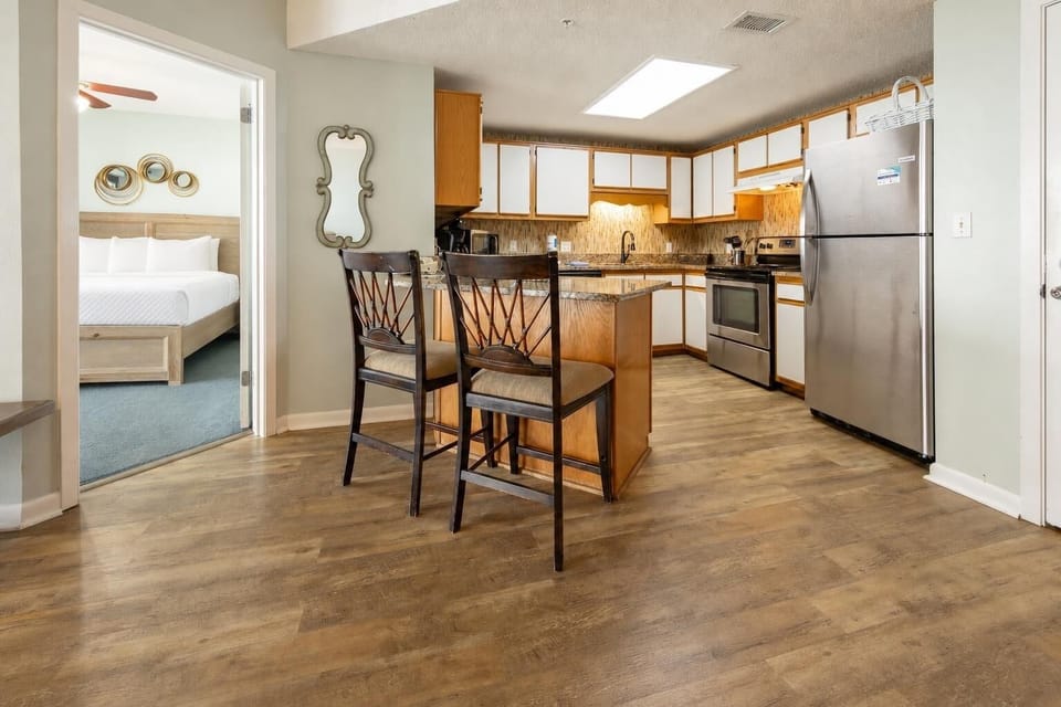 The kitchen invites you to prepare fresh meals while enjoying the glow of under-cabinet lighting and cozy stools