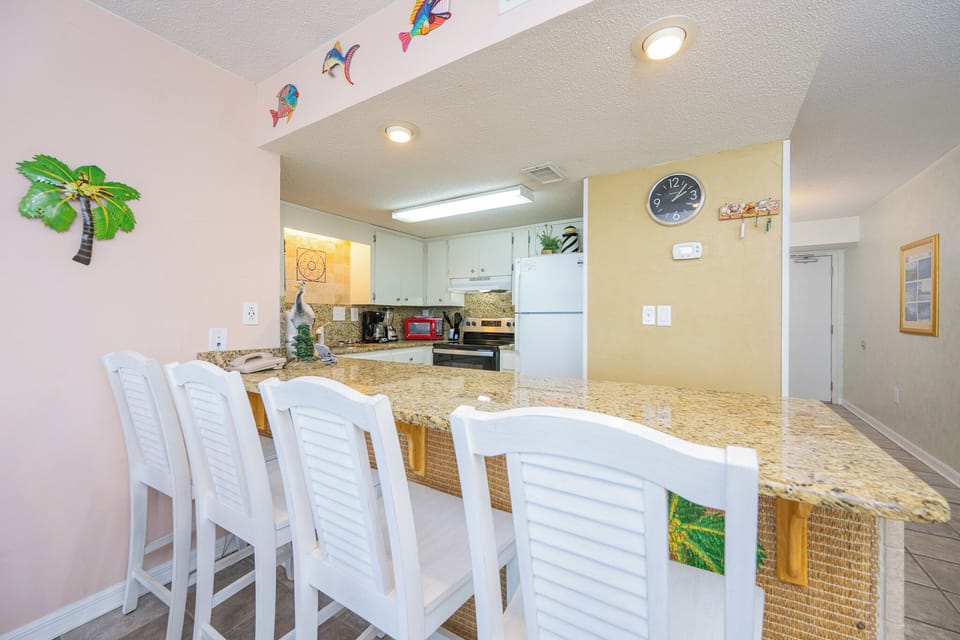 Gather around the bar-style seating, sipping drinks and sharing laughter as you enjoy time together in the kitchen space