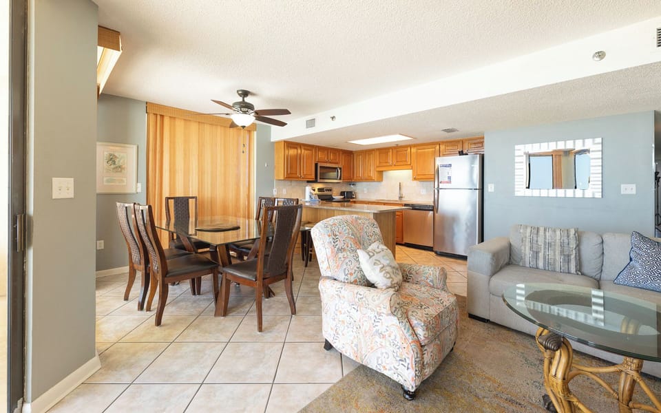 Gather around the glass dining table in this open living room to share laughter and vacation stories