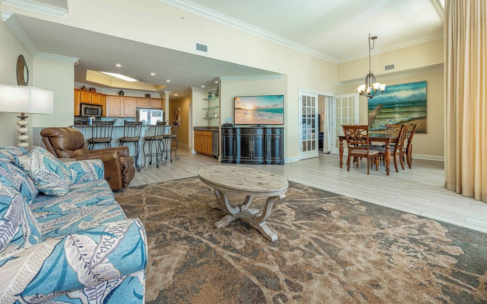 Relax in the inviting living area, perfect for family gatherings, enjoying a cozy atmosphere by the plush sofa