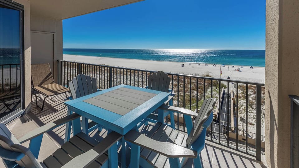 Savor meals at the blue table while enjoying breathtaking views of the tranquil water and nearby beach