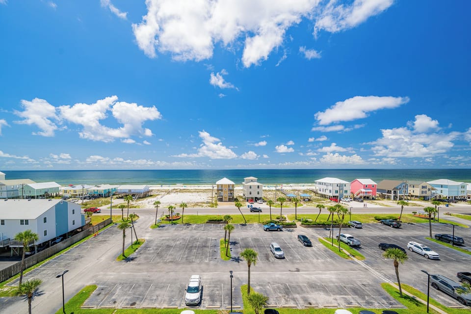The bright space offers stunning beach views, with vibrant blue skies and nearby palm trees enhancing the relaxing atmosphere