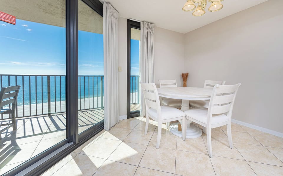 Dine at the round table while enjoying the expansive views through the beachfront balcony windows