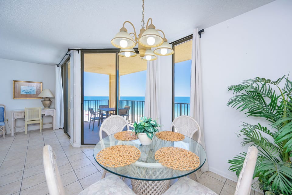 Bright sunlight fills the dining area as you watch waves roll along the coast from your balcony table